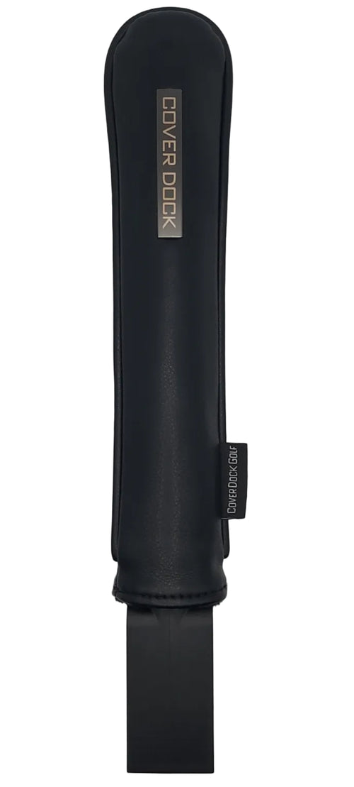A black protective leather sleeve that organizes your golf club head cover by  Cover Dock, shown horizontally on a light gray background. The pouch features a metallic gold brand logo and a small black tag near the top right.